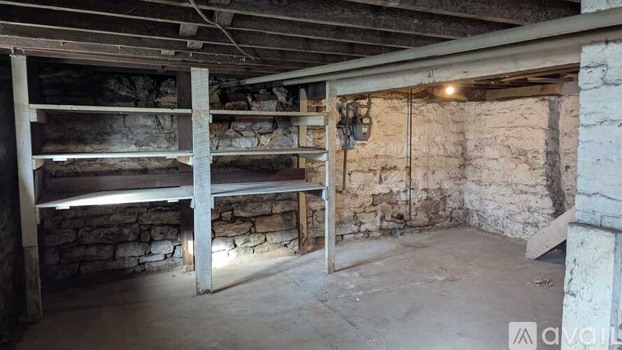 A room with stone walls and wooden beams.