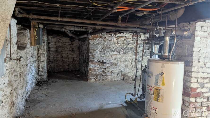 A room with a white container and a pipe system.