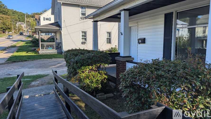 A house with a white door and a wooden deck.