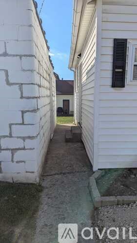 A white house with a small window and a door.