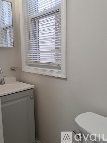 A room with wooden floors and a light fixture on the ceiling.