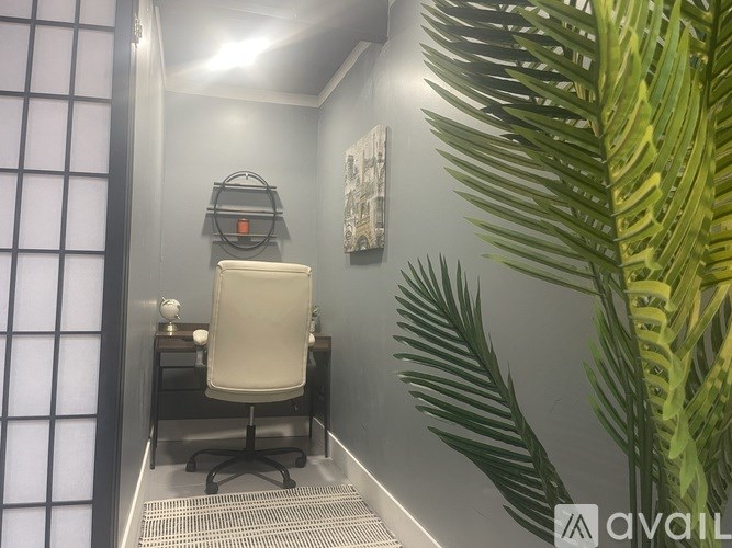 A room with a desk and a chair.