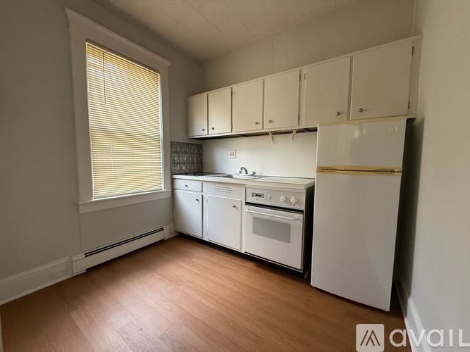 A room with a window and a carpeted floor.