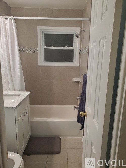 A bathroom with a toilet, sink, and bathtub.