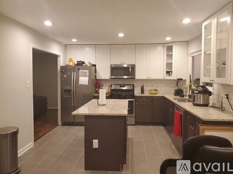 A kitchen with a refrigerator, microwave, and oven.