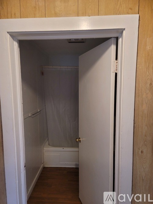 A small bathroom with a toilet and a bathtub.