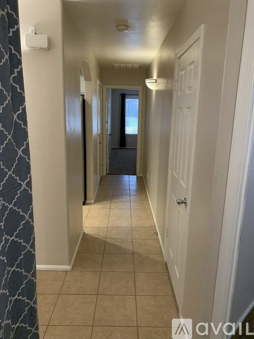 A long hallway with a door at the end.