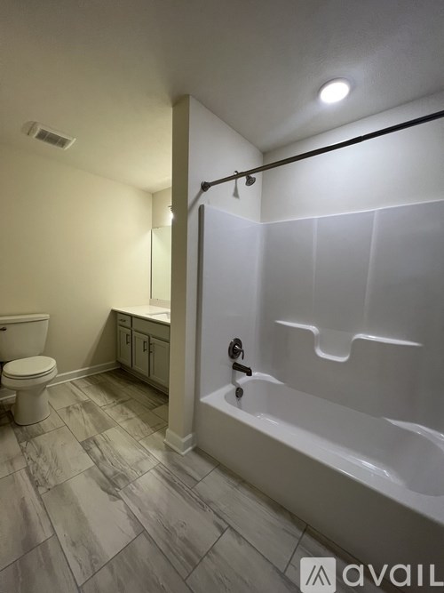 A bathroom with a toilet, sink, and bathtub.