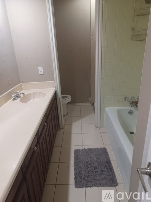A bathroom with a toilet, sink, and bathtub.