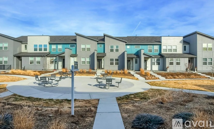 A row of modern houses with a circular patio in the foreground.