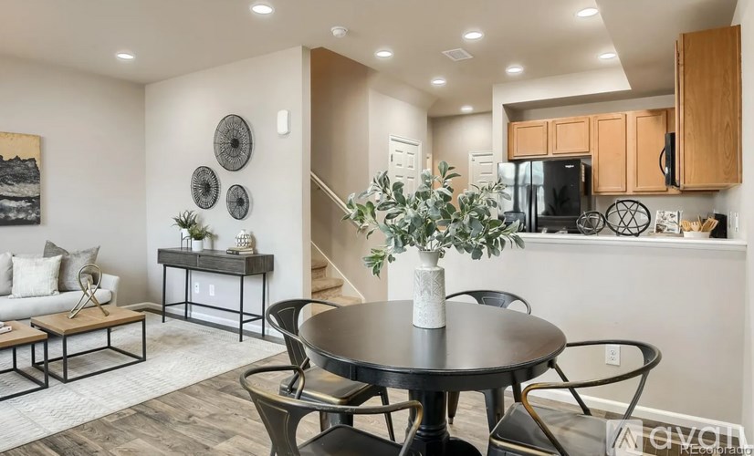 A modern dining room with a round table and chairs.