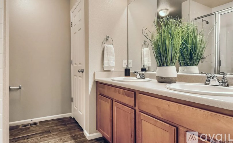 A bathroom with wooden cabinets and a white sink.