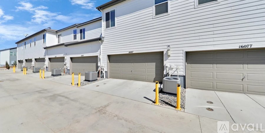 A row of garage doors in front of a building.