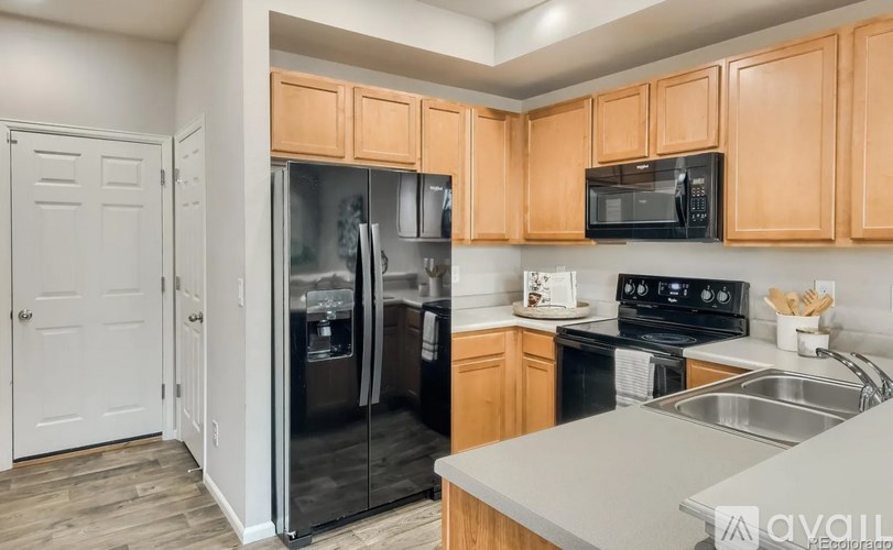 A kitchen with wooden cabinets and stainless steel appliances.