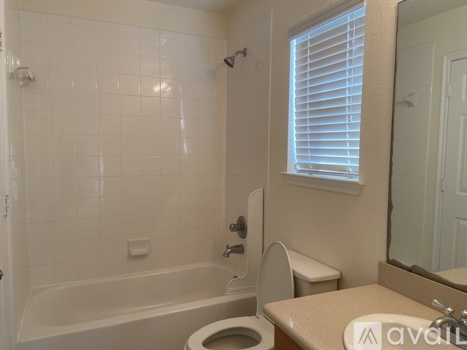 A bathroom with a toilet, sink, and bathtub.