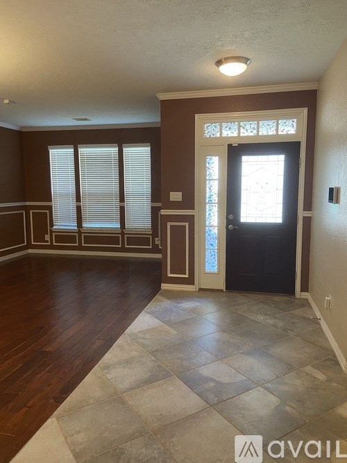 A room with brown walls and a black door.