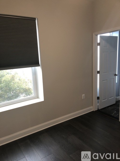 A room with a window and a door.