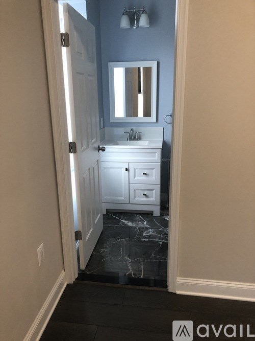 A bathroom with a sink and mirror.