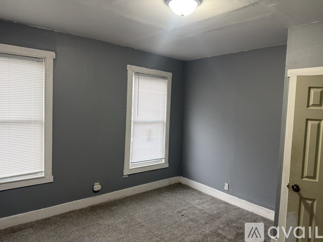 A room with grey walls and a carpeted floor.