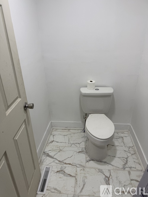 A room with a door and carpeted floor.