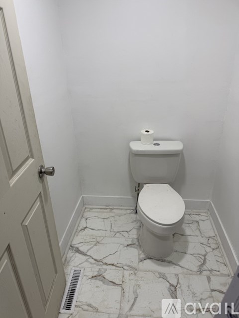 A room with a door and carpeted floor.