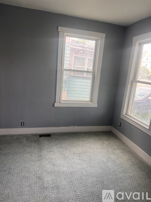 A room with grey walls and a window.