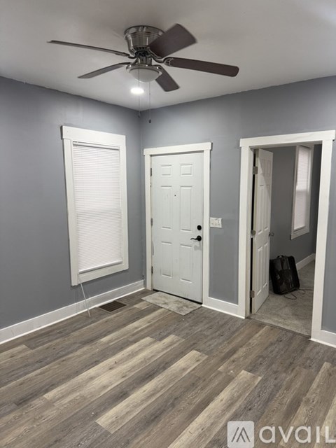 A room with grey walls and a window.