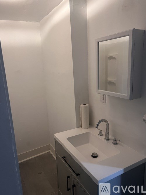 A bathroom with a sink and mirror.