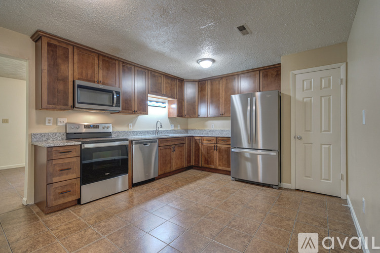 A kitchen with wooden cabinets and stainless steel appliances.