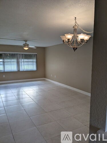 A room with a chandelier and a ceiling fan.