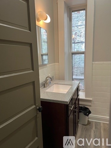 A bathroom with a sink and a window.