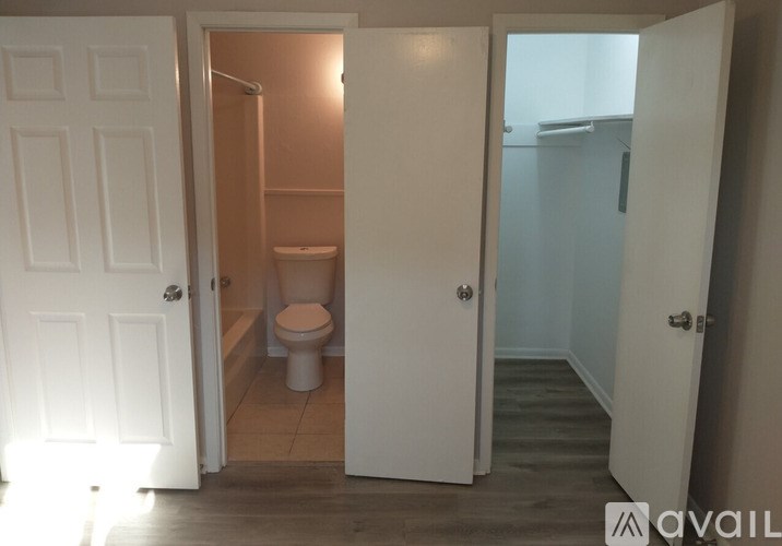 A bathroom with a toilet and a shower.