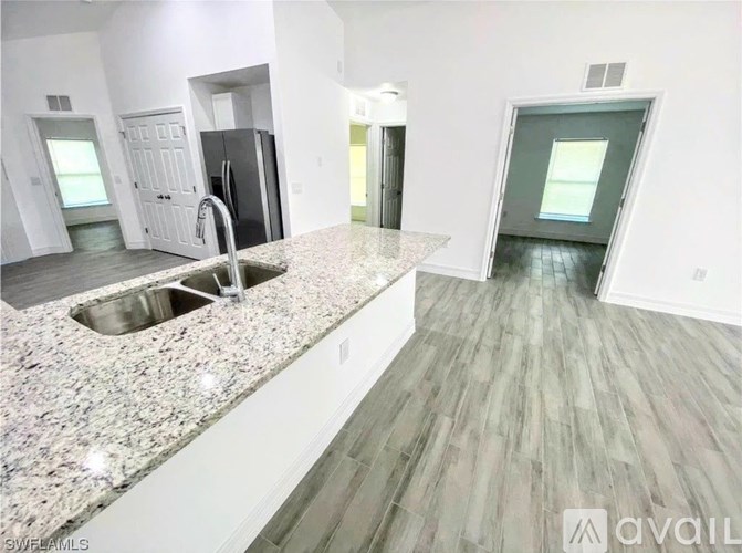 A kitchen with granite countertops and a sink.