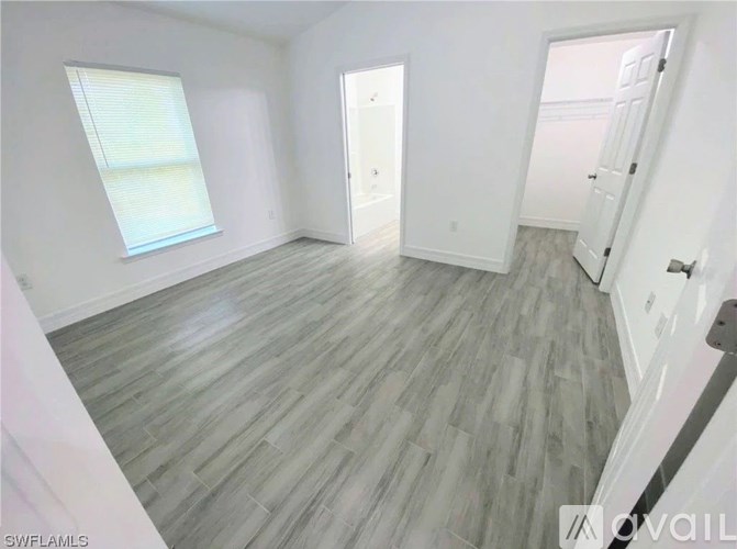 A room with a wooden floor and white walls.