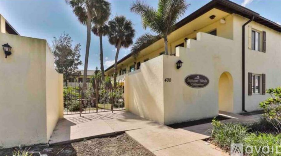 A white house with a black number 400 on the front wall.