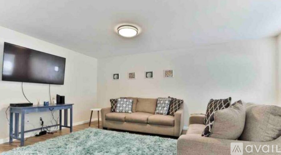 A living room with a couch, a television, and a table.