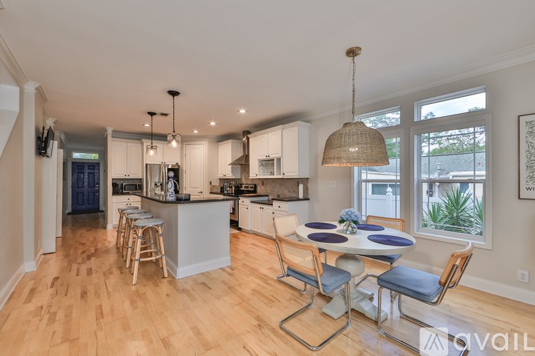 A kitchen with a table and chairs in front of a window.