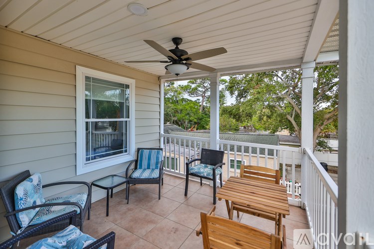 A patio with a ceiling fan and furniture.