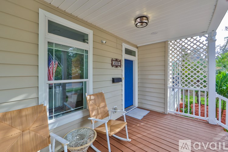 A small balcony with a chair and table.