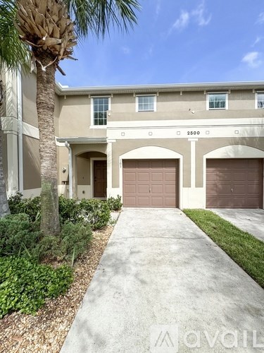 A house with a palm tree in front of it.