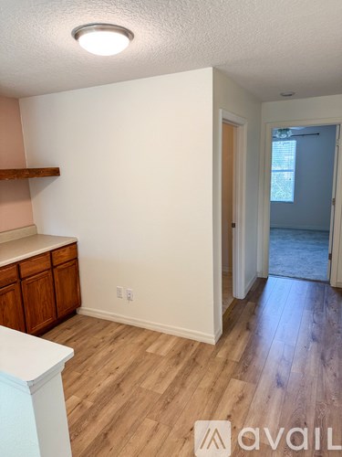 A room with wooden floors and a white countertop.