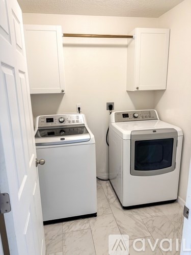 A small kitchen with a washer and dryer.