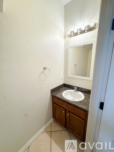 A bathroom with a sink and mirror.