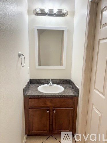 A bathroom with a sink and a mirror.
