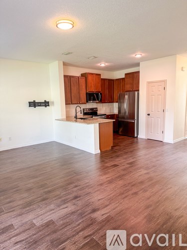 A kitchen with wooden floors and a white countertop.
