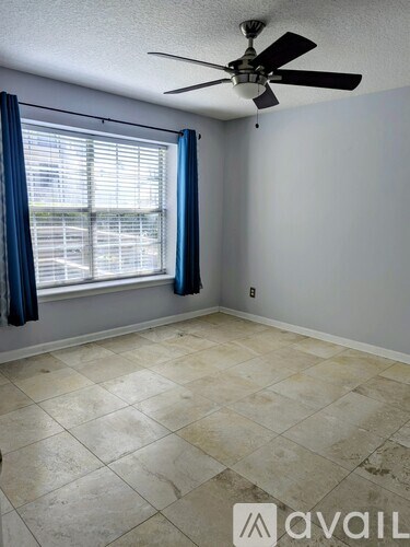 A kitchen with white cabinets and a stainless steel refrigerator.