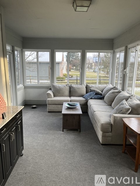 A living room with a grey couch and a coffee table.