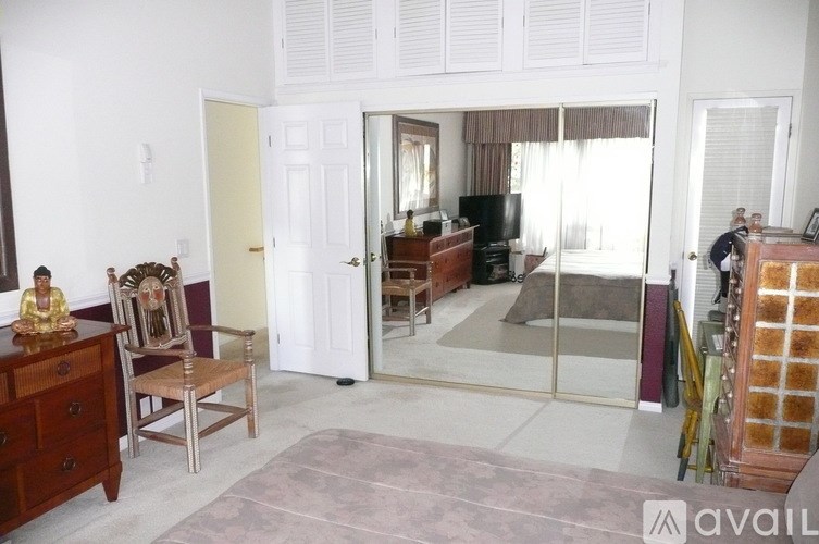 A room with a wooden chair and a wooden cabinet.