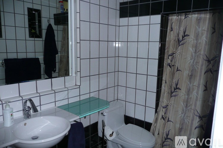 A bathroom with a white sink and a white toilet.
