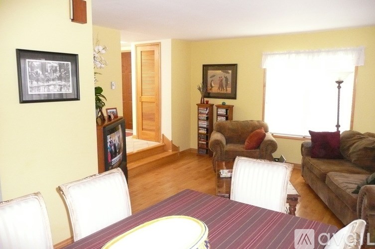 A living room with a couch, chairs, and a coffee table.